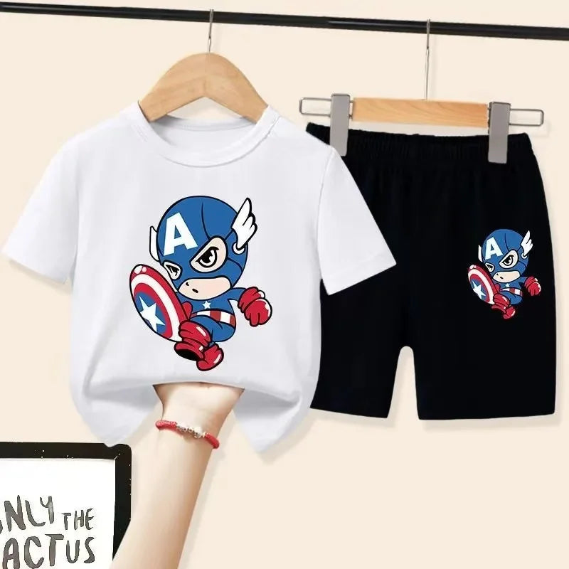 White t-shirt and black shorts with Captain America design on hangers against a beige background.