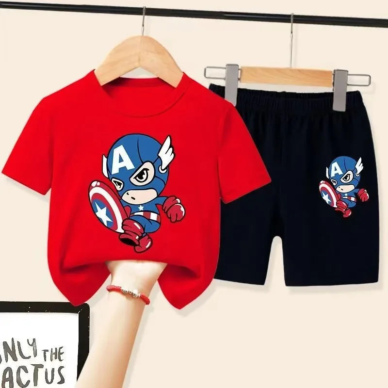 Red t-shirt and black shorts with Captain America design on hangers against a beige background.
