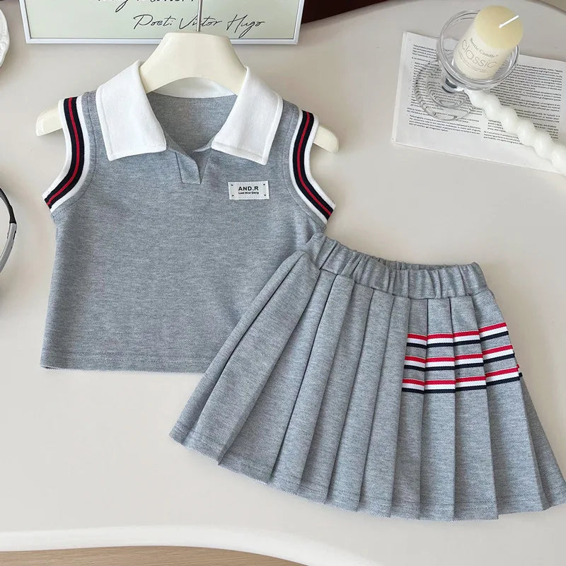 Children's gray dress with striped details on a white surface