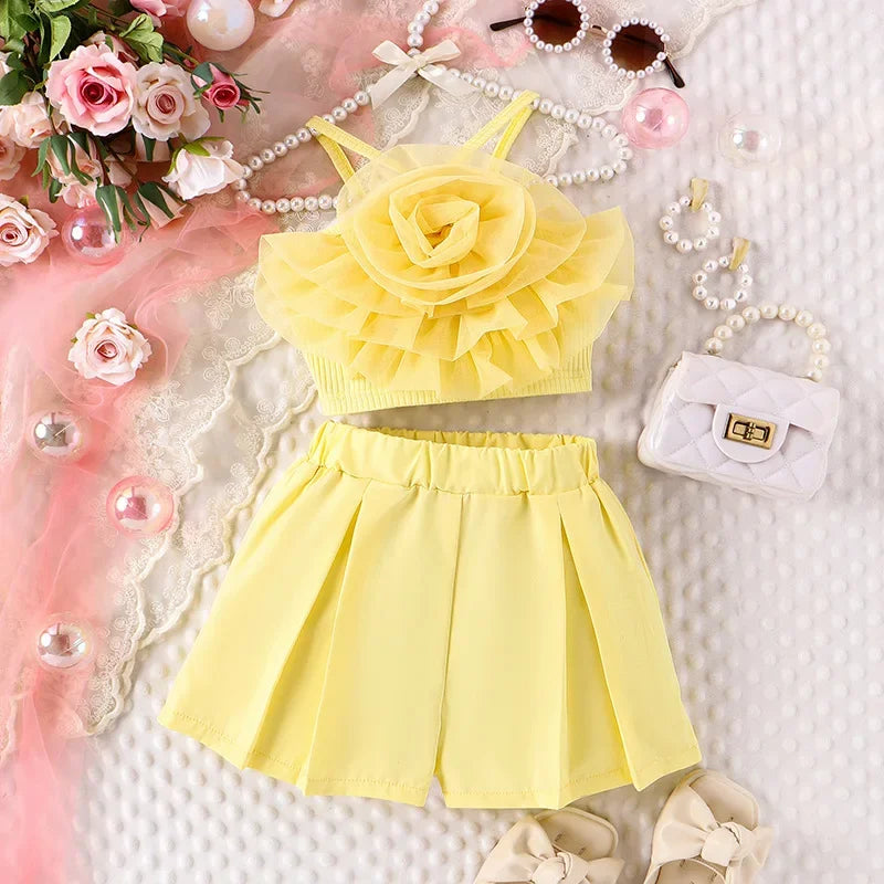 Yellow floral top and shorts set with accessories on a decorative background