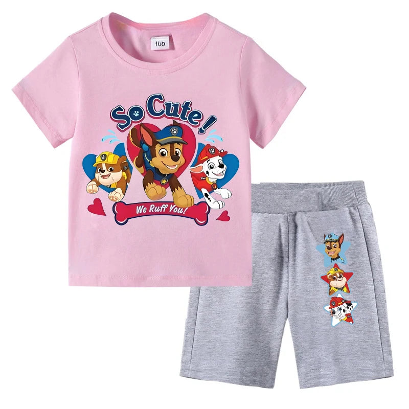 Children's pink t-shirt and gray shorts set with Paw Patrol graphics on a white background