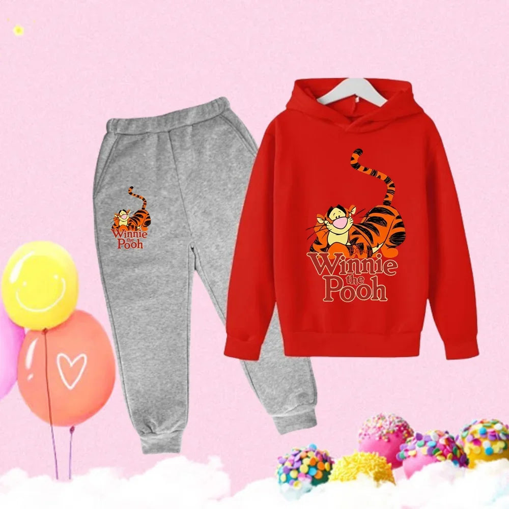 Red hoodie and gray sweatpants with Tigger from Winnie the Pooh on a pink background with balloons and candy.
