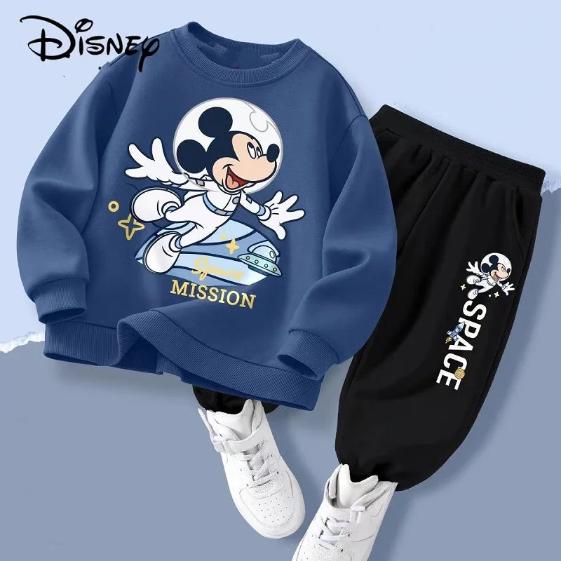 Children's outfit with blue sweatshirt and black pants featuring a space-themed design, Disney logo visible.