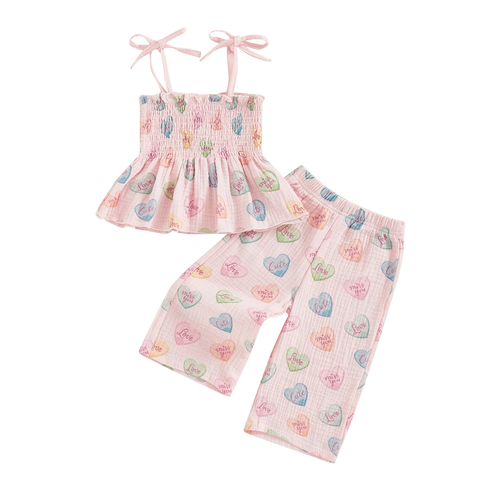 Children's outfit with top and pants featuring heart patterns on a white background