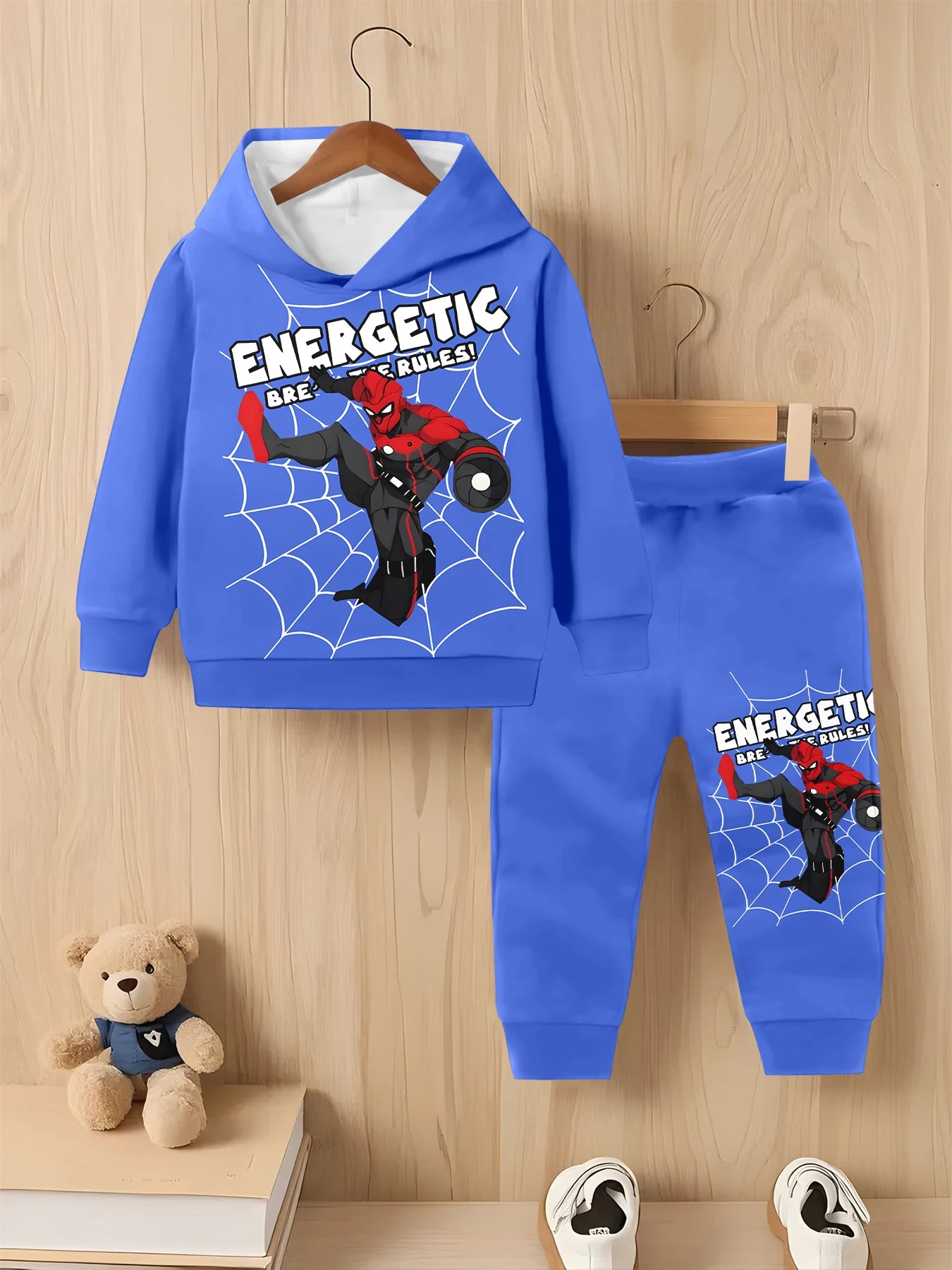Blue children's hoodie and pants set with superhero design on a wooden background