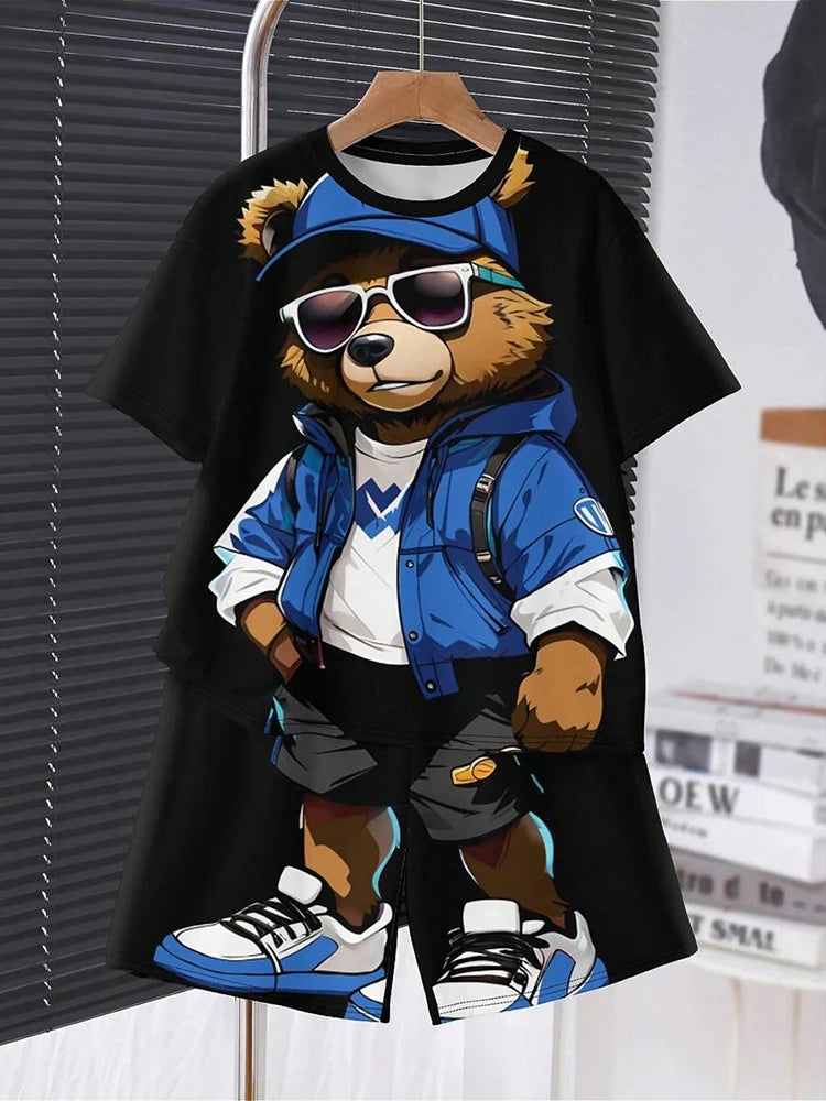 Black t-shirt with a bear graphic wearing sunglasses, a blue jacket, and sneakers on a hanger.