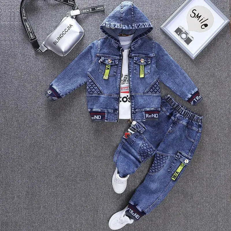 Children's denim outfit with jacket and pants on a gray surface